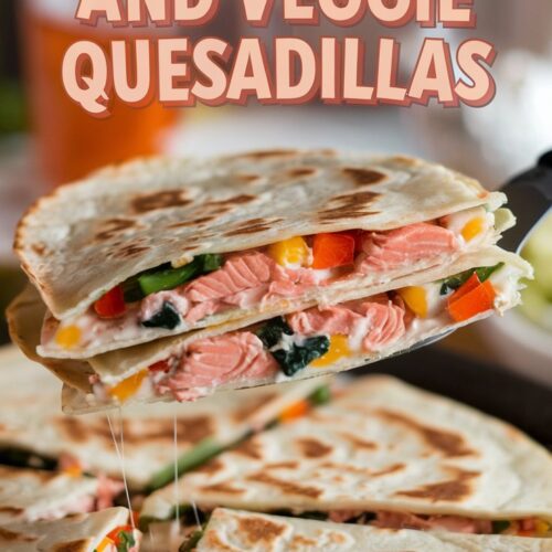 Close-up of a quesadilla revealing its cheesy salmon and veggie-packed interior as it is lifted by a spatula. The text "Canned Salmon Pink Salmon and Veggie Quesadillas" features in a playful font against a casual family dinner table setting.