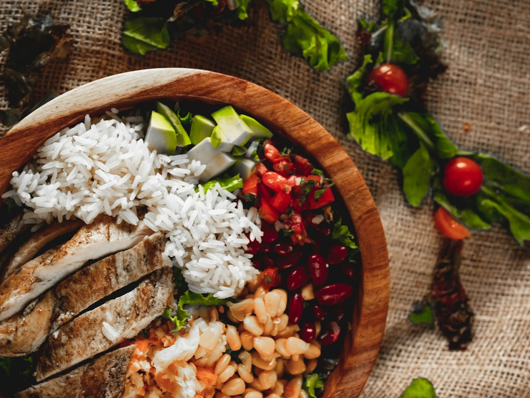 Chicken and rice bowl with beans and fresh vegetables