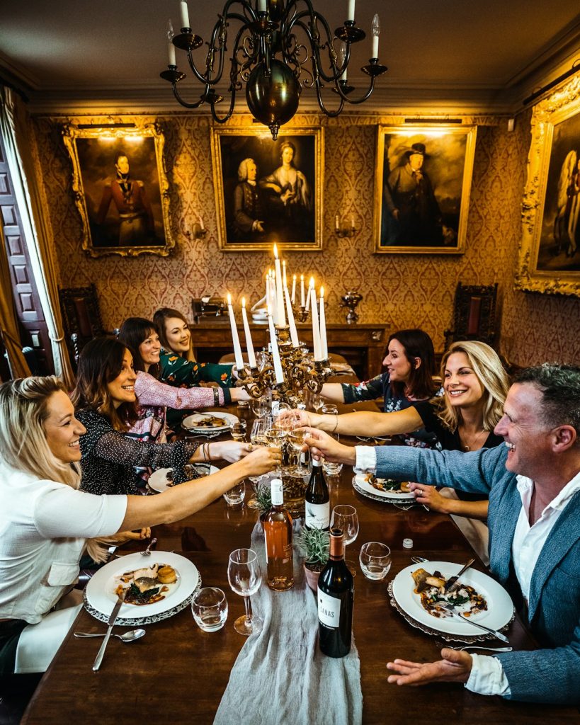 Friends sharing a toast at a candlelit dinner table