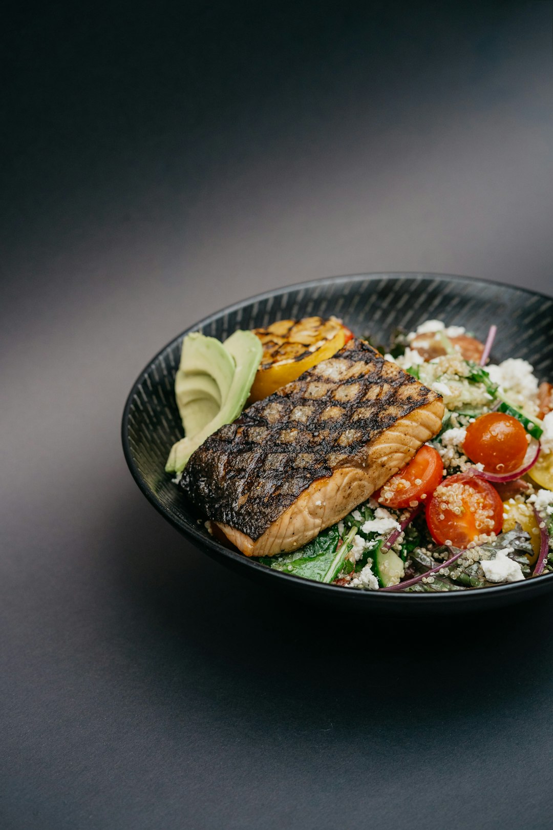 Grilled salmon with avocado and tomato salad