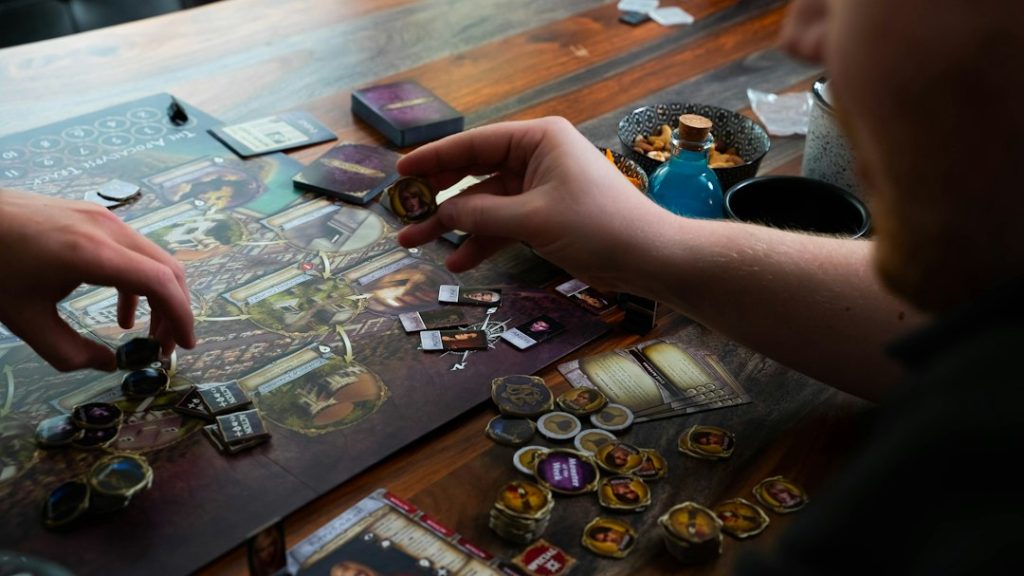 Hands moving pieces during a tabletop board game