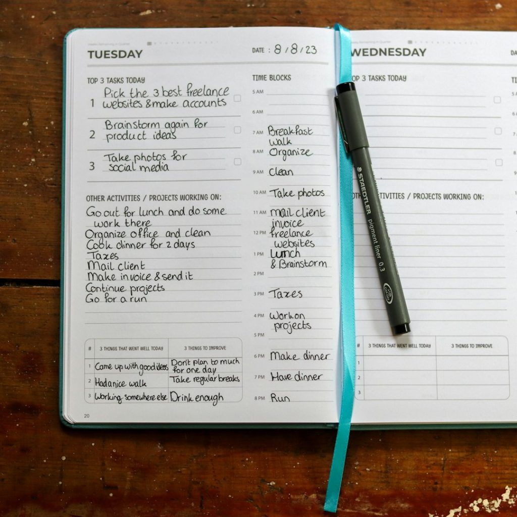 Open weekly planner filled with handwritten tasks and a pen